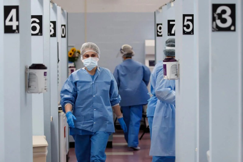 Medical personnel in the COVID-19 medical screening annex at NYC Health + Hospitals Metropolitan in New York. (AP Photo/John Minchillo)