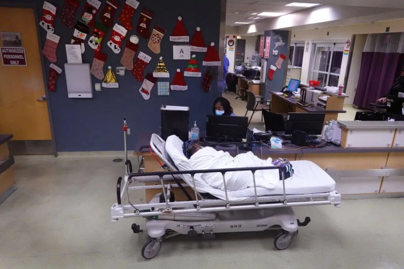 Black patient waiting in hallway of hospital during COVID-19 pandemic