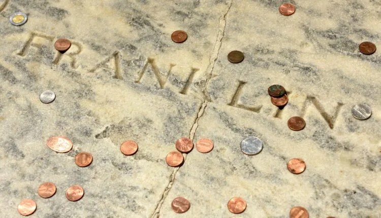 Why Do Philadelphians Throw Pennies Onto Benjamin Franklin’s Grave?