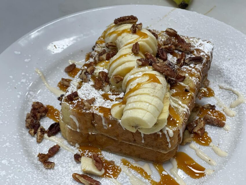 French toast with nuts, bananas, and syrup