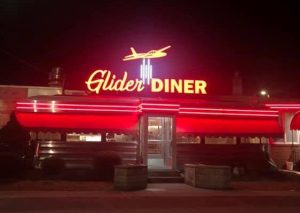 An outside view of The Glider Diner at night.