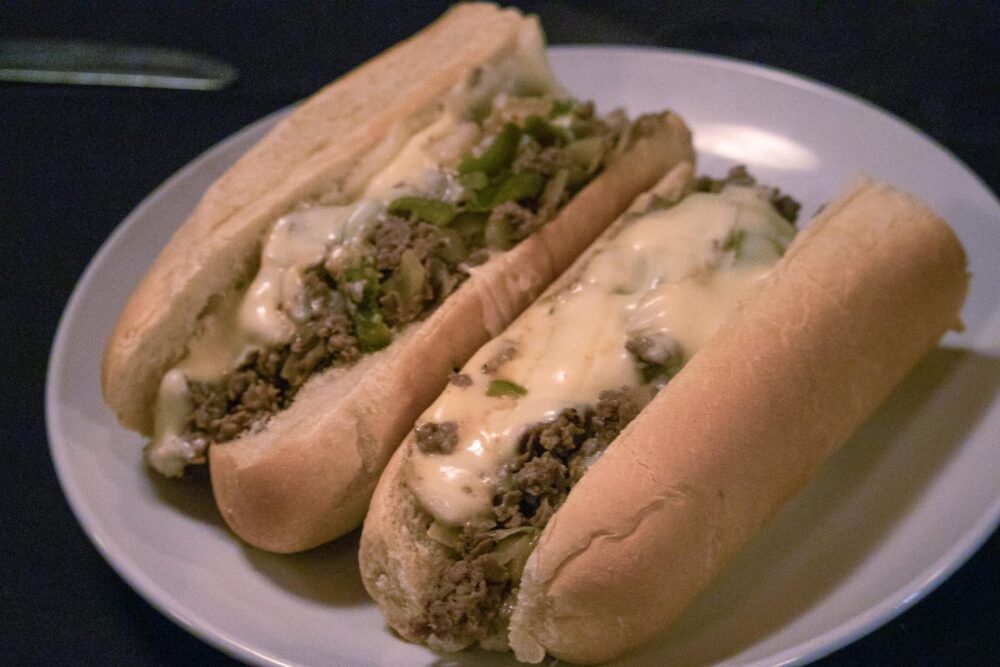 Two cheesesteaks side by side.