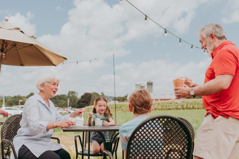 family enjoying Pennsylvania ice cream together outside