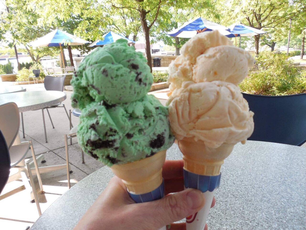 a hand holding ice cream cones 