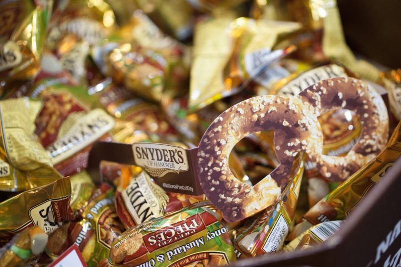 an array of salted pretzels and snyder's pretzel bags