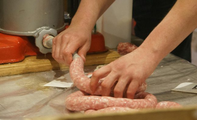 a man making hand-made sausage